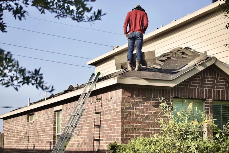 Professional roofer working on a residential roof in Lakewood Village